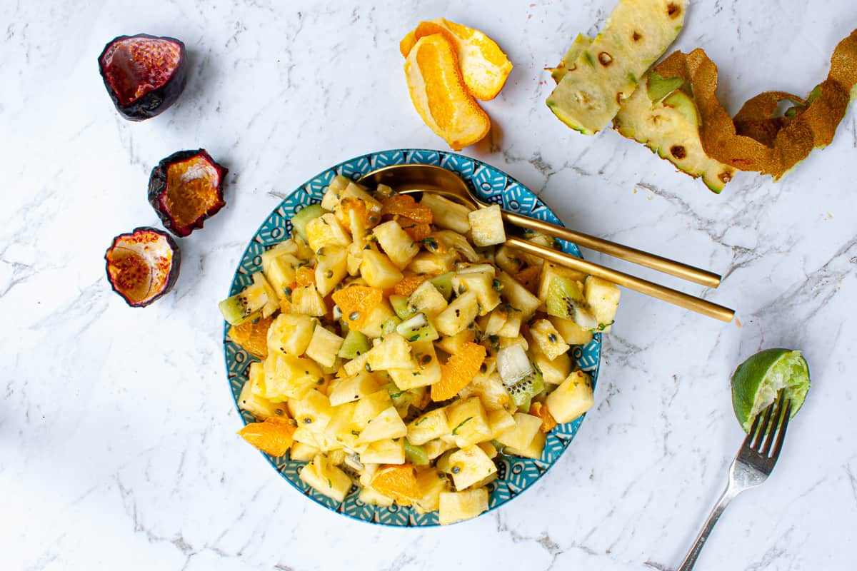 Fruit salad piled high in a blue patterned bowl.