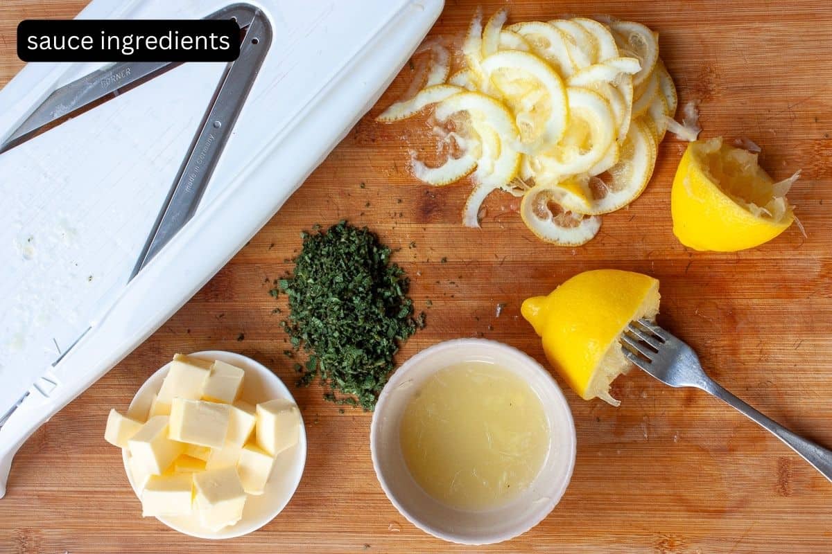 Ingredients required to make lemon, sage and brown butter sauce laid out on a wooden board.