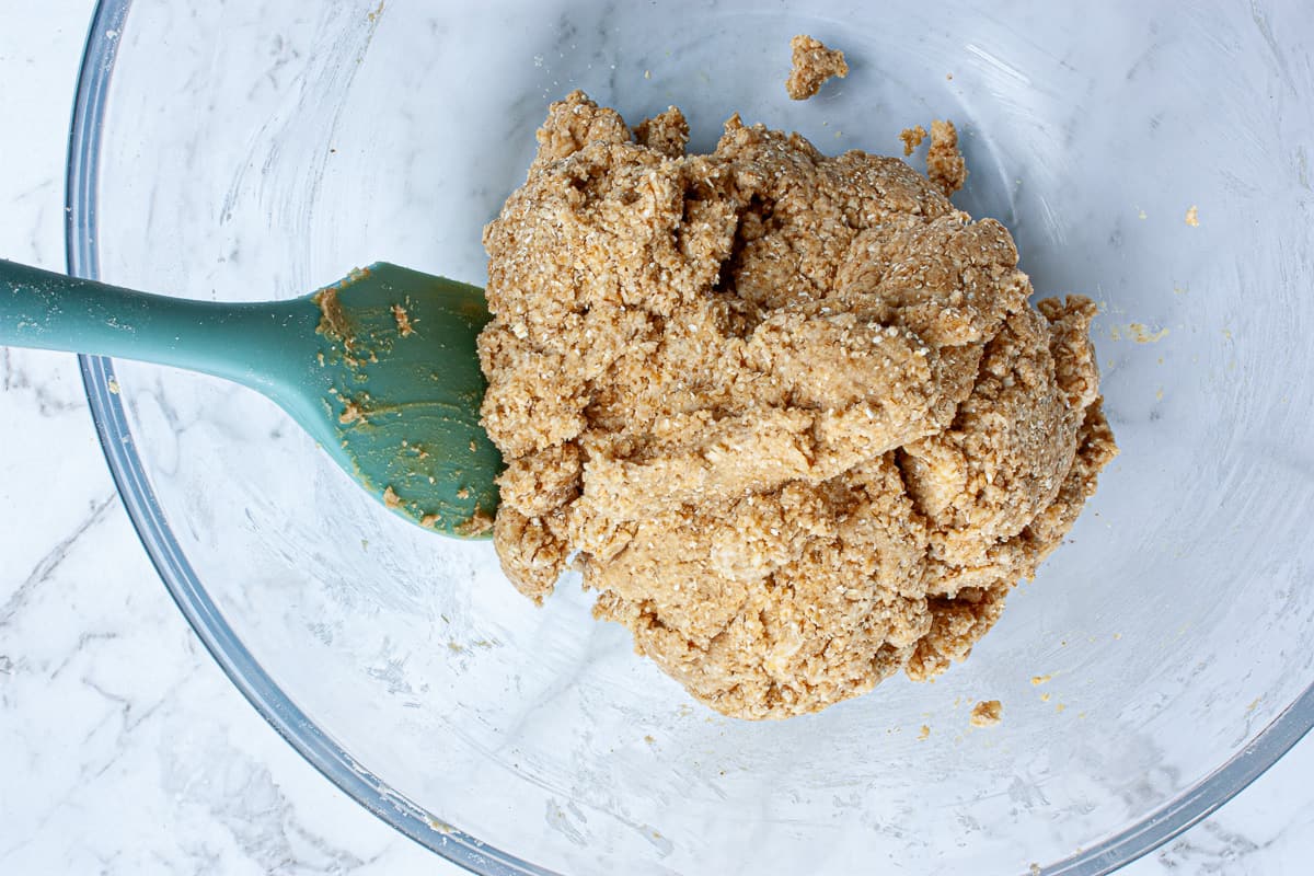 A ball of craggy dough in a glass bowl.