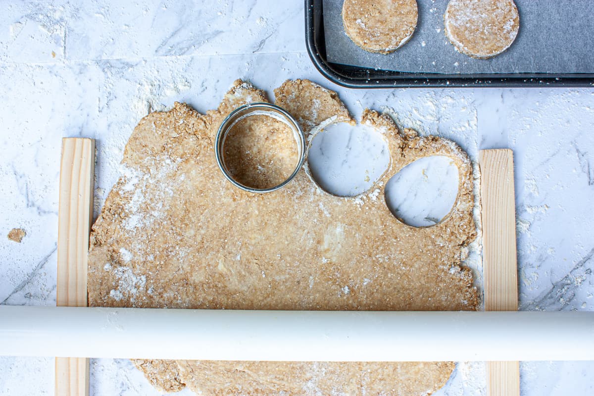 Rounds being cut out of a sheet of pastry.