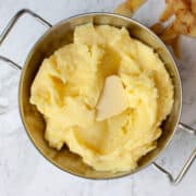 Creamy buttery mash in a silver serving bowl.