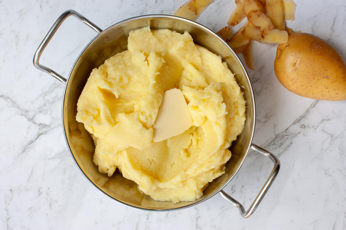 Creamy buttery mash in a silver serving bowl.