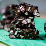 A stack of rock road pieces - chocolate studded with pink and white marshmallows and flecks of green.