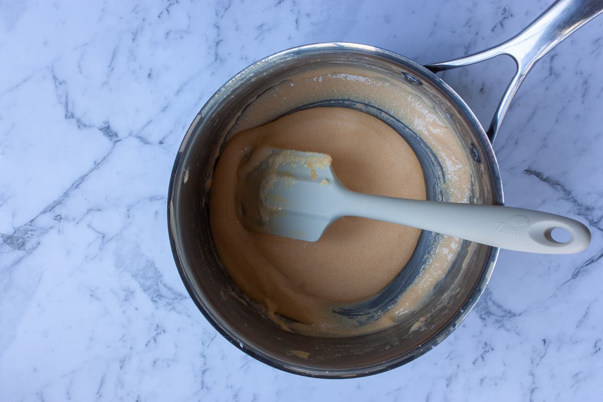 Blanched egg yolks in a saucepan.