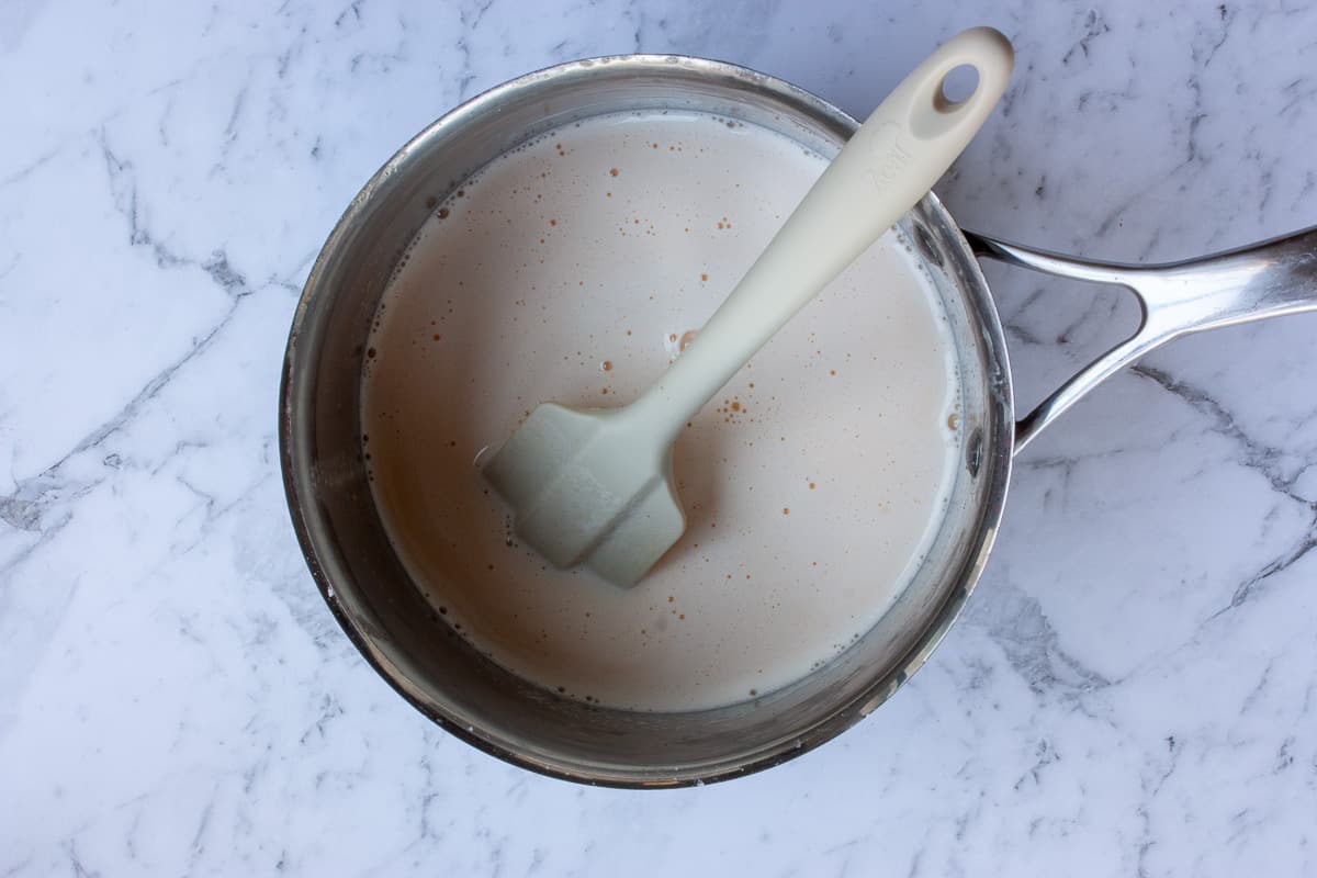 Thin custard in a saucepan before heating to thicken.