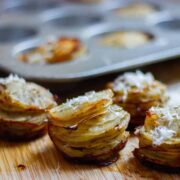 Potato stacks removed from the muffin tray and set on a wooden surface.