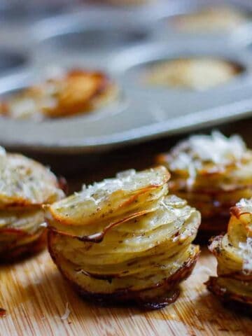 Potato stacks removed from the muffin tray and set on a wooden surface.