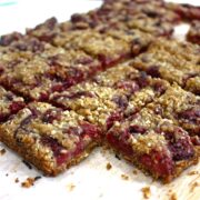 Slice cut into small rectangles on a wooden chopping boards. Some loose crumbs around the edge.