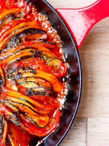 Baked ratatouille tian in a cast iron pan.